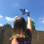 Photo of Evie and her beautiful silver-studded blue butterfly, fluttering in the wind!