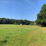 photo of a large recreation ground, with woodland around the edge.